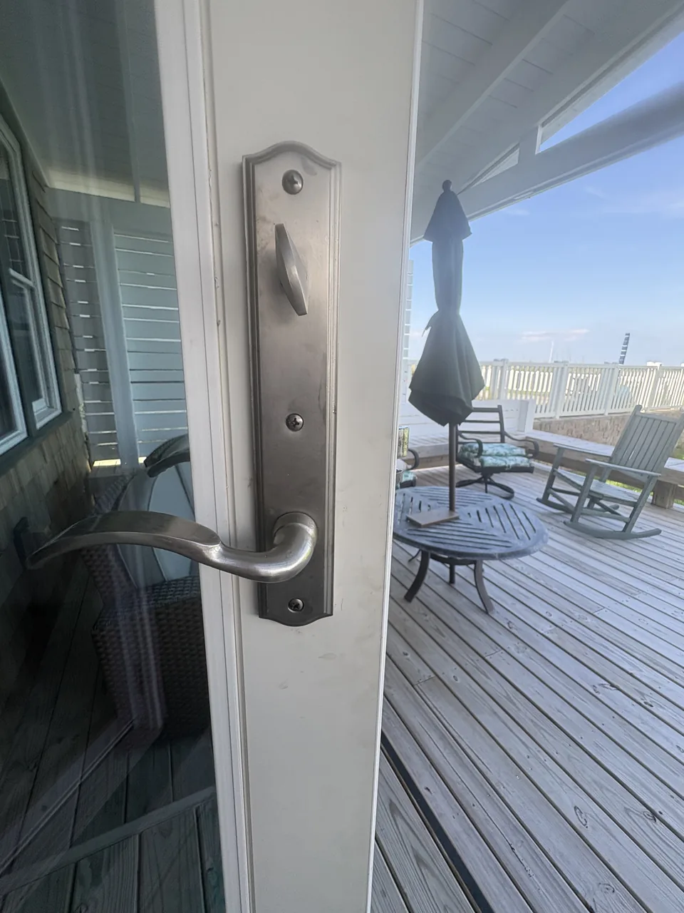 Silver lever handle and thumbturn fitted to a residential glass door
